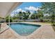 A refreshing in-ground pool is surrounded by a brick patio and lush landscaping at 219 Miramar Ne Blvd, St Petersburg, FL 33704