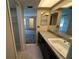 Bathroom vanity features a sink with storage below, tile flooring, and a large mirror, providing ample light at 229 Mary Dr # 229, Oldsmar, FL 34677