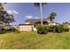 Spacious backyard with healthy green lawn, fencing, and well-maintained shrubbery at 2600 Forest Run Ct, Clearwater, FL 33761