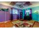 Eclectic bedroom with colorful walls, unique ceiling art, and a stylish vanity area at 2600 Forest Run Ct, Clearwater, FL 33761