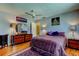 Bedroom featuring gray walls, a ceiling fan, and hardwood flooring at 2600 Forest Run Ct, Clearwater, FL 33761
