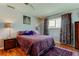 Comfortable bedroom featuring a plush purple bed, dark furniture, and abundant natural light at 2600 Forest Run Ct, Clearwater, FL 33761
