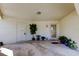 Spacious carport area with white walls, plants and two entrance doors at 2600 Forest Run Ct, Clearwater, FL 33761