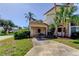 Home's front exterior featuring a carport and lush landscaping at 2600 Forest Run Ct, Clearwater, FL 33761