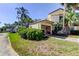 Charming home with lush landscaping, mature trees, and a welcoming entrance at 2600 Forest Run Ct, Clearwater, FL 33761