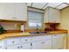 The kitchen features stainless steel sink, white appliances, and laminate counters at 2600 Forest Run Ct, Clearwater, FL 33761
