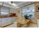 Bright eat-in kitchen showcasing white cabinets, laminate counters, and tiled floors at 2600 Forest Run Ct, Clearwater, FL 33761