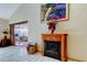Open-concept living area features a fireplace and access to the outdoor patio at 2600 Forest Run Ct, Clearwater, FL 33761