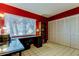 Bright office space with red walls, a desk, built-in shelves, and ample storage space at 2600 Forest Run Ct, Clearwater, FL 33761