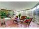 Covered and screened patio showcasing cozy seating, colorful cushions, and sliding glass doors to the home at 2600 Forest Run Ct, Clearwater, FL 33761
