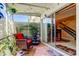 Screened patio with comfortable seating, lush plants, a water feature and sliding glass doors to the interior at 2600 Forest Run Ct, Clearwater, FL 33761