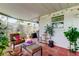 Inviting screened patio with comfortable seating, potted plants and stylish outdoor decor at 2600 Forest Run Ct, Clearwater, FL 33761