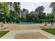 Community pool with plenty of lounge seating and mature surrounding trees at 2600 Forest Run Ct, Clearwater, FL 33761