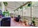 Cozy sunroom filled with plants, natural light, and a tranquil seating area at 2600 Forest Run Ct, Clearwater, FL 33761