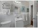 Bright bathroom with white fixtures, neutral walls, and decor at 2613 Upton S St, Gulfport, FL 33711