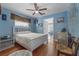 Bright bedroom with hardwood floors, ceiling fan, and white furniture at 2613 Upton S St, Gulfport, FL 33711