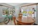 Cozy dining area featuring a round wooden table, natural light, and quaint decorations like ukuleles on the wall at 2613 Upton S St, Gulfport, FL 33711