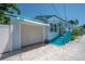 Quaint blue house with a garage and updated facade, featuring vibrant trim and a well-kept driveway at 2613 Upton S St, Gulfport, FL 33711
