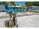 Bright blue home with unique architectural details, a well-manicured lawn, and charming curb appeal at 2613 Upton S St, Gulfport, FL 33711
