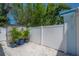 Well-kept white fence, attractive landscaping with potted plants, and convenient storage shed at 2613 Upton S St, Gulfport, FL 33711