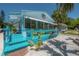 Charming beach house with vibrant blue porch featuring cozy seating area, and a whimsical nautical themed decoration at 2613 Upton S St, Gulfport, FL 33711