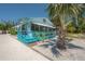 Charming blue beach house with inviting, vibrant covered front porch, creating a warm and cheerful atmosphere at 2613 Upton S St, Gulfport, FL 33711