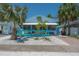 Charming beach house with a playful marlin decoration and an inviting, bright blue, covered front porch at 2613 Upton S St, Gulfport, FL 33711