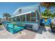 Quaint beach house with a cozy porch featuring yellow chairs, ideal for enjoying the outdoors in a relaxed setting at 2613 Upton S St, Gulfport, FL 33711