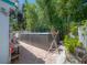 Backyard view of a lovely hot tub on a brick patio with surrounding tropical landscaping at 2613 Upton S St, Gulfport, FL 33711