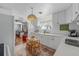 Kitchen displaying white cabinets, a cozy dining nook, and open access to the adjacent living space at 2613 Upton S St, Gulfport, FL 33711