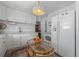 This kitchen features white cabinetry, stainless steel appliances, and a glass top rattan table at 2613 Upton S St, Gulfport, FL 33711