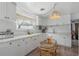 Bright kitchen showcasing white cabinets, light countertops, and a stylish hanging lamp fixture at 2613 Upton S St, Gulfport, FL 33711