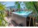 Pool view with tropical landscaping, and building with fun surf decor and outdoor kitchen at 2613 Upton S St, Gulfport, FL 33711