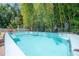 A backyard pool with tropical landscaping and comfortable lounge chairs nearby at 2613 Upton S St, Gulfport, FL 33711