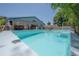 A backyard pool, tropical landscaping, and an entertainment area with surf decor at 2613 Upton S St, Gulfport, FL 33711