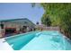A backyard pool, tropical landscaping, and an entertainment area with outdoor kitchen at 2613 Upton S St, Gulfport, FL 33711