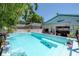 Backyard features pool, tropical landscaping and building with surfboard decor at 2613 Upton S St, Gulfport, FL 33711