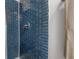 Bathroom shower featuring blue tile and modern fixtures at 2613 Upton S St, Gulfport, FL 33711