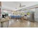 Bright sunroom with tile flooring, comfortable seating, and stainless steel refrigerator, perfect for relaxing at 2613 Upton S St, Gulfport, FL 33711