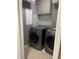 Laundry room with front loading washer and dryer, upper cabinets and tile backsplash at 2950 Willowleaf Ln, Wesley Chapel, FL 33544