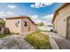View of the backyard showing detached structure, walkway, and the side of the main property at 3213 W Ivy St, Tampa, FL 33607