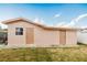 A detached structure in the backyard featuring two doors on a grassy lawn and a clear sky at 3213 W Ivy St, Tampa, FL 33607