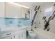 Bathroom features tiled walls, vanity with storage, and a tub with shower at 3213 W Ivy St, Tampa, FL 33607
