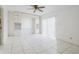 This bedroom features tile floors, a ceiling fan, built-in shelving and white cabinets for storage at 3213 W Ivy St, Tampa, FL 33607