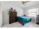 Bedroom featuring tile floors, a dresser, a small bed, and a ceiling fan at 3213 W Ivy St, Tampa, FL 33607