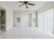 This bedroom features tile floors, a ceiling fan, built-in shelving and white cabinets for storage at 3213 W Ivy St, Tampa, FL 33607