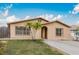 Charming home featuring two palm trees, a well-maintained lawn, and a concrete driveway at 3213 W Ivy St, Tampa, FL 33607