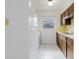 Kitchen featuring wood cabinets, window and white appliances at 3213 W Ivy St, Tampa, FL 33607