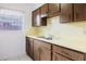 Kitchen featuring wooden cabinets, light countertops, and a stainless steel faucet at 3213 W Ivy St, Tampa, FL 33607
