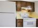 Efficient kitchen with white appliances and classic wood cabinets at 3213 W Ivy St, Tampa, FL 33607
